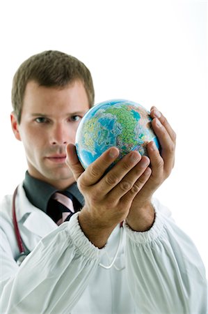 Doctor holding globe Stock Photo - Premium Royalty-Free, Code: 644-03659600