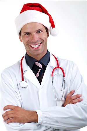 funny pose - Doctor with stethoscope and Santa's hat Foto de stock - Sin royalties Premium, Código: 644-03659649