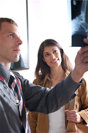 skeleton woman - Doctor and patient looking at xray Stock Photo - Premium Royalty-Free, Code: 644-03659683