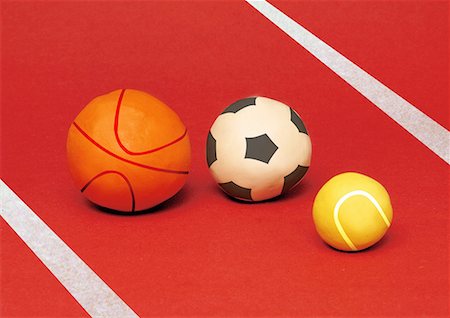 A basketball, a soccer ball, and a tennis ball Stock Photo - Premium Royalty-Free, Code: 645-01538515