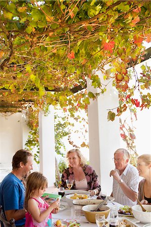 Family eating at table outdoors Stock Photo - Premium Royalty-Free, Code: 649-04248973