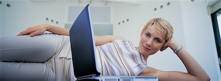 simsearch:649-05648787,k - Woman laying on floor with laptop Stock Photo - Premium Royalty-Free, Code: 649-04249116