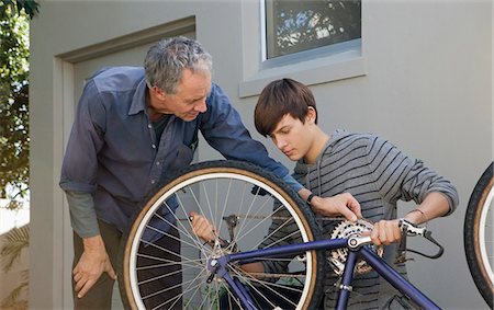 simsearch:649-05656972,k - Father helping son repair bicycle Stock Photo - Premium Royalty-Free, Code: 649-04827489