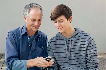 simsearch:649-05656972,k - Father and son using cell phone together Stock Photo - Premium Royalty-Free, Code: 649-04827494