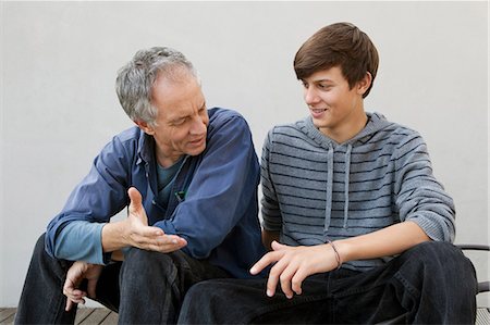 simsearch:649-05656972,k - Father and son sitting together Stock Photo - Premium Royalty-Free, Code: 649-04827499