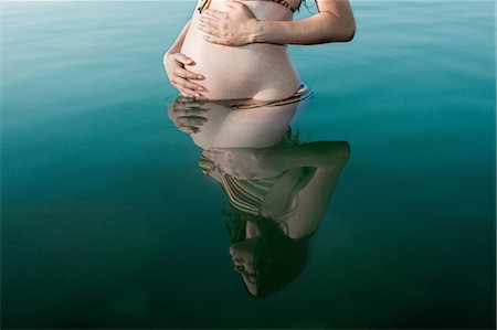 pregnant woman in swimsuit - Pregnant woman standing in lake Stock Photo - Premium Royalty-Free, Code: 649-04827520