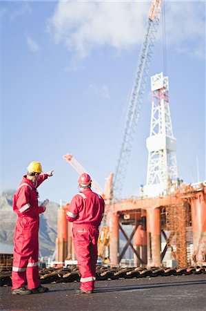 Workers talking on oil rig Stock Photo - Premium Royalty-Free, Code: 649-04827631