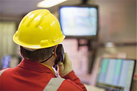 Worker watching security cameras Stock Photo - Premium Royalty-Free, Code: 649-04827685