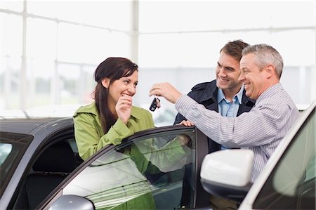Car salesman giving keys to customer Stock Photo - Premium Royalty-Free, Code: 649-05521292