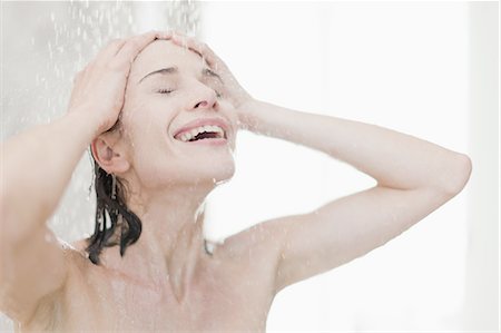 shower bath - Smiling woman taking shower Stock Photo - Premium Royalty-Free, Code: 649-05521608