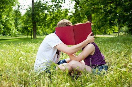 shield - Teenagers hiding behind book in park Stock Photo - Premium Royalty-Free, Code: 649-05555613