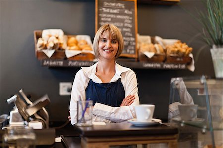 Smiling woman working in cafe Stock Photo - Premium Royalty-Free, Code: 649-05648982