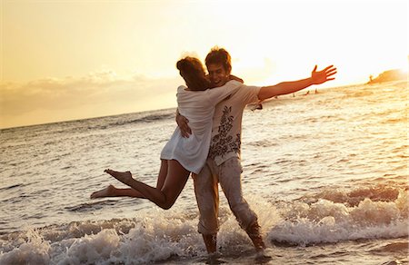 romantic beach sunset - Couple playing in waves at beach Stock Photo - Premium Royalty-Free, Code: 649-05649908