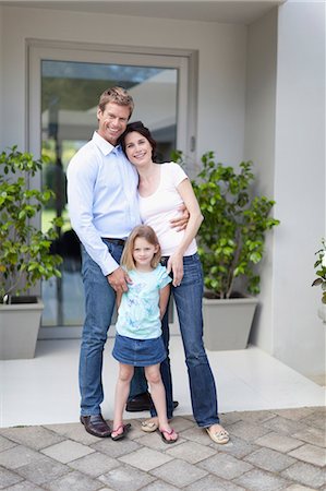 family on patio - Family smiling outside front door Stock Photo - Premium Royalty-Free, Code: 649-05657226