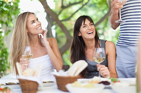 eating outside restaurant - Friends having wine at table outdoors Stock Photo - Premium Royalty-Free, Code: 649-05657370