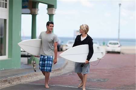 Teenage boys carrying surfboards Stock Photo - Premium Royalty-Free, Code: 649-05657486