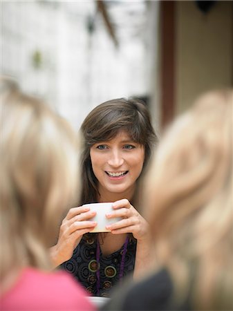 Women having coffee at sidewalk cafe Stock Photo - Premium Royalty-Free, Code: 649-05657886