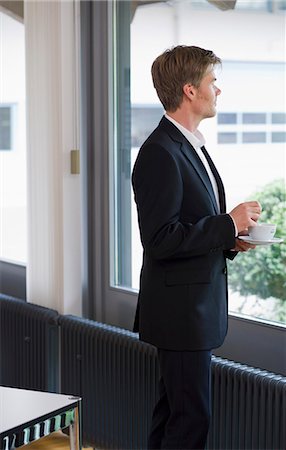 simsearch:649-07119200,k - Businessman standing at window in office Stock Photo - Premium Royalty-Free, Code: 649-05801066