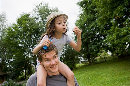 simsearch:632-05604245,k - Girl with bubbles on fathers shoulders Stock Photo - Premium Royalty-Free, Code: 649-05801125