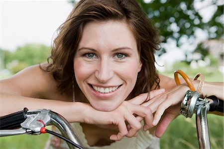 simsearch:649-05819818,k - Woman leaning on bicycle outdoors Stock Photo - Premium Royalty-Free, Code: 649-05801151