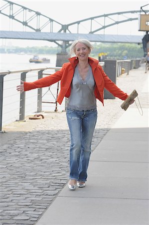 senior activities - Older woman walking along riverfront Stock Photo - Premium Royalty-Free, Code: 649-05801582