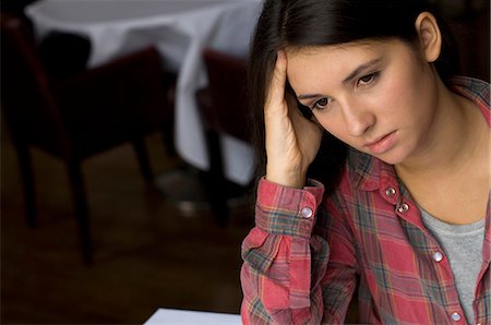 Close up of girl rubbing her forehead Stock Photo - Premium Royalty-Free, Code: 649-05801848