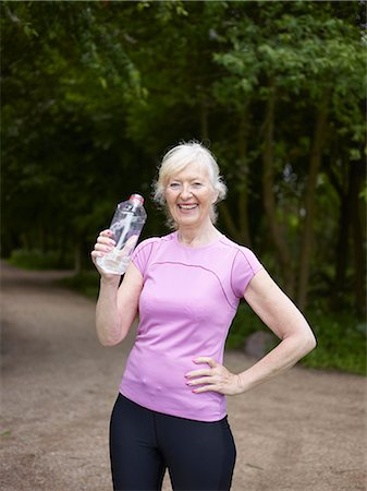 runners resting - Older woman drinking from water bottle Stock Photo - Premium Royalty-Free, Code: 649-05801860