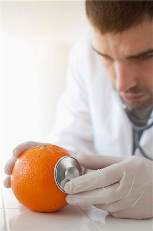 Scientist using stethoscope on orange Stock Photo - Premium Royalty-Free, Code: 649-05802379