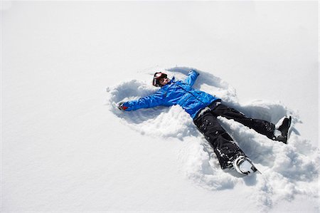 Boy making snow angel Stock Photo - Premium Royalty-Free, Code: 649-05819586