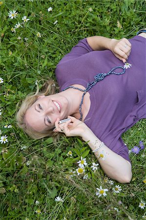 simsearch:649-05819818,k - Woman talking on cell phone in grass Stock Photo - Premium Royalty-Free, Code: 649-05819809