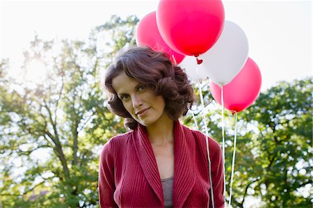 simsearch:649-05819818,k - Woman carrying balloons outdoors Stock Photo - Premium Royalty-Free, Code: 649-05819847