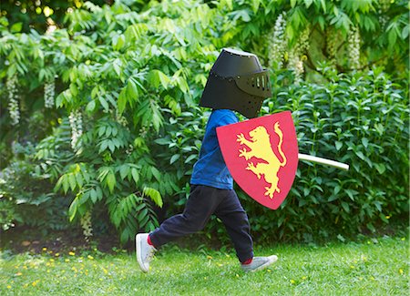 shield - Boy playing with sword in backyard Stock Photo - Premium Royalty-Free, Code: 649-05820015