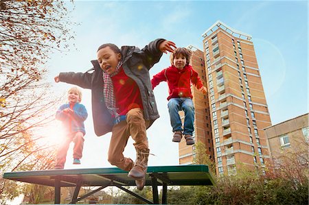 fall fun - Children jumping for joy in park Stock Photo - Premium Royalty-Free, Code: 649-05820458