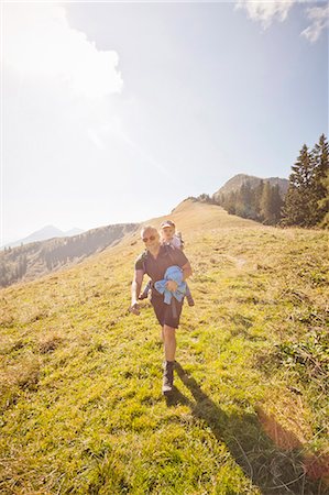 family and field - Man carrying daughter on his back Stock Photo - Premium Royalty-Free, Code: 649-05820615