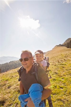 Man carrying daughter on his back Stock Photo - Premium Royalty-Free, Code: 649-05820616