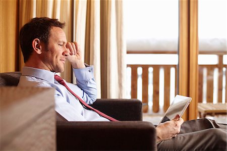 sitting at a hotel - Businesswoman using tablet in hotel room Stock Photo - Premium Royalty-Free, Code: 649-05820988