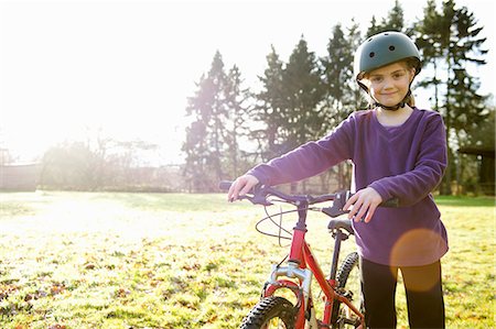 Girl walking with bicycle in meadow Stock Photo - Premium Royalty-Free, Code: 649-05949493