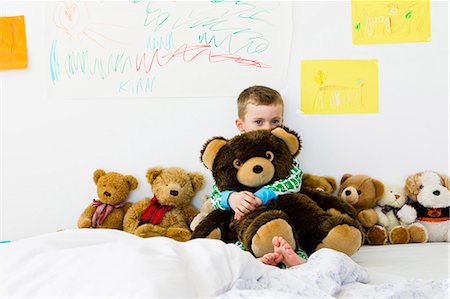 friend kids - Boy hugging teddy bear on bed Stock Photo - Premium Royalty-Free, Code: 649-05949805