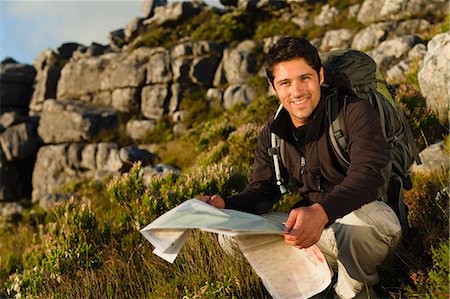 Hiker reading map in rocky field Fotografie stock - Premium Royalty-Free, Codice: 649-05949897