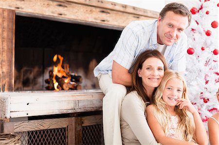 fireplace - Family relaxing by Christmas tree Stock Photo - Premium Royalty-Free, Code: 649-05949990
