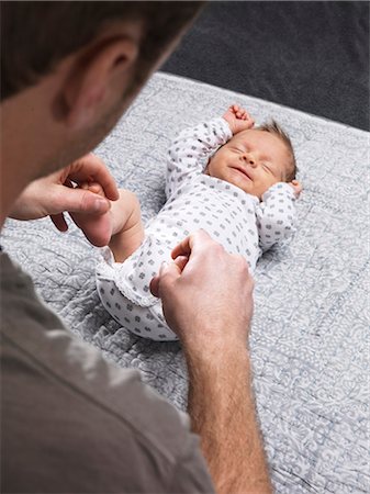 simsearch:632-08001820,k - Father tickling infants feet on table Stock Photo - Premium Royalty-Free, Code: 649-05950614