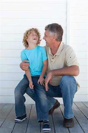 Smiling father and son on deck Stock Photo - Premium Royalty-Free, Code: 649-06000375