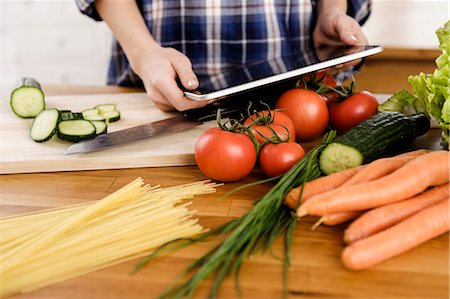 Woman using tablet computer to cook Stock Photo - Premium Royalty-Free, Code: 649-06000453