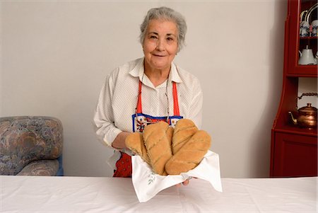 Older woman making bread in living room Stock Photo - Premium Royalty-Free, Code: 649-06000696