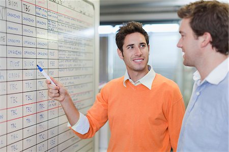 Businessman writing on whiteboard Stock Photo - Premium Royalty-Free, Code: 649-06000825