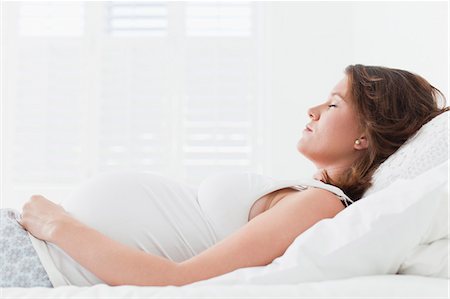 simsearch:649-06622033,k - Pregnant woman sleeping on bed Stock Photo - Premium Royalty-Free, Code: 649-06001059