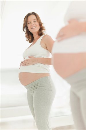 pregnancy - Woman admiring pregnant belly Stock Photo - Premium Royalty-Free, Code: 649-06001093