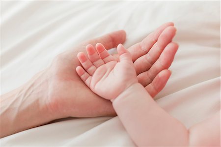 palm of hand - Close up of mother and babys hands Stock Photo - Premium Royalty-Free, Code: 649-06001144