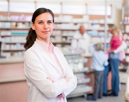 portrait of boy with arms crossed - Smiling pharmacist standing in store Stock Photo - Premium Royalty-Free, Code: 649-06001313