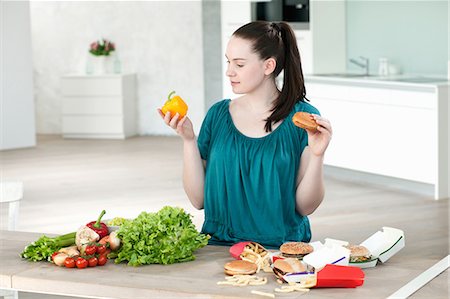 simsearch:649-05520883,k - Woman with fast food and vegetables Stock Photo - Premium Royalty-Free, Code: 649-06001605